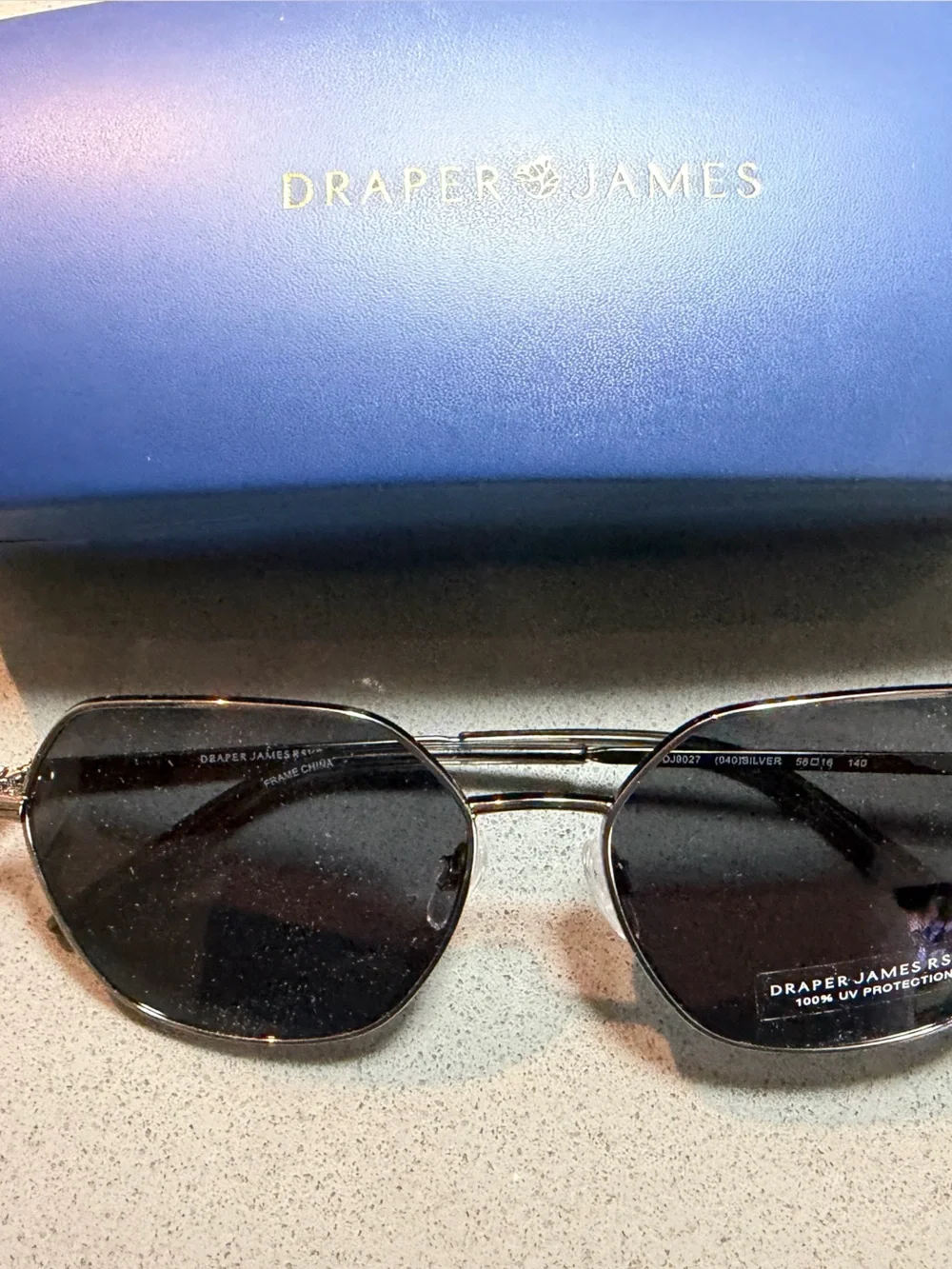Draper James Silver-Tone Sunglass Arm with Navy Background